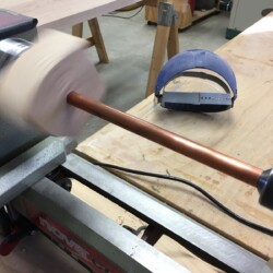 A quick fixture to clean up the copper tubes with 400 grit emery paper.