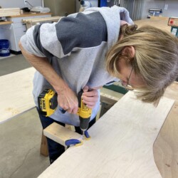 Linda drilling holes for strap hinges