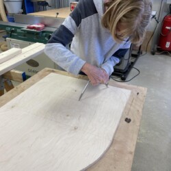 Linda laying out curves on the rollaway stone door