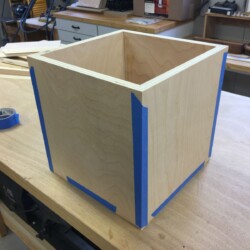 Painters tape holds all four sides and the top in place. (The top is on the bottom in this picture.)