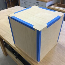 Pin nails driven through the painters tape secure the joints will the glue is curing.