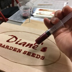 Filling the carvings with a 10 ml syringe.