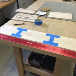 Using painters tape hinges for aligning and folding mitered box corners.