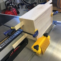 Separating the lid from the body on the tablesaw.