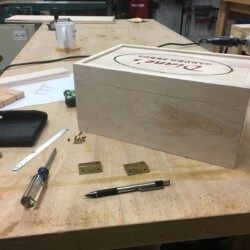 Fitting hinges with tiny (fragile) brass screws before finishing.