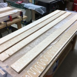 Applying glue to five boards at a time for glue up of the top slab
