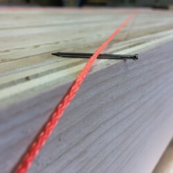 Small nails offset one string by its diameter