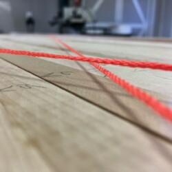 When the strings touch, the two rails are parallel