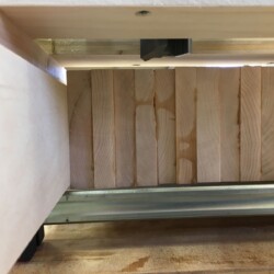 Underside of router sled showing relation of the bit to the slab