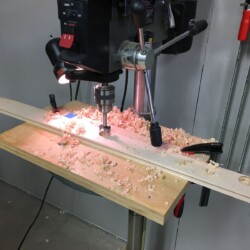 Drilling cup hinge mounting holes in one stile per door prior to assembly