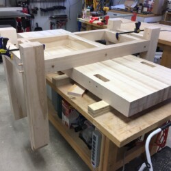 Leg and rail subassemblies ready to lift into place