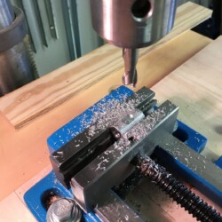 To couple RH and LH threaded rods, aluminum bushings were drilled and tapped with 5/16-18 RH and LH threads, and then a wrench flat was milled on the side.