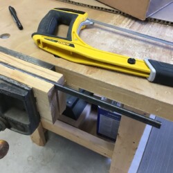 Cutting the RH threaded rod to length with a hacksaw.