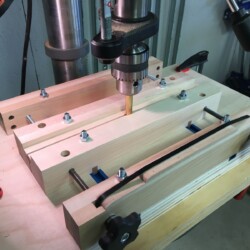 A 1/2 inch brass rod chucked in the drill press aligns the vise jaws. Once aligned, the entire mechanism is clamped to the drill press table.