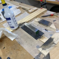 Initial surfacing of the bar with progressively finer grits of Emery paper and water