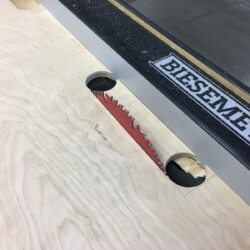 Plunge cutting the straight portion of the openings by raising the table saw blade