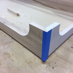 The painter's tape acts as a hinge, maintaining joint alignment and preventing glue squeeze out