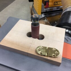 Refining the jig cutout with the oscillating spindle sander