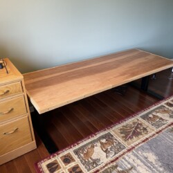 In place at the lowest position about 25 inches to the desk top