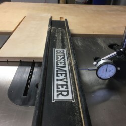 Using a dial indicator to make very small adjustments to the rip fence.