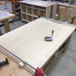 Assembling maple border pieces to the birch field of the top.