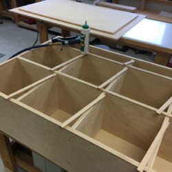 Applying 1/4 thick maple edging to finish the exposed plywood edges.