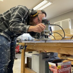 Lucas cleaning up the edges against the template with a flush trimming router bit