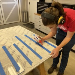 Emily applying drops of CA glue to attach an original window to the new material