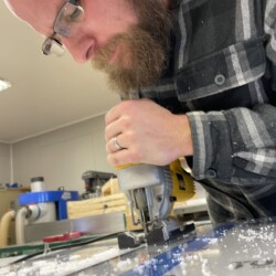 Lucas rough cutting outside of the attached template with the jigsaw