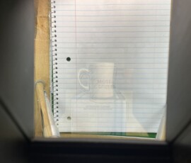 The view down through the Camera Lucida, with the mug's image superimposed on the notepad