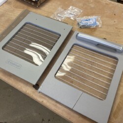 The replacement oven door (left) came with hardware but no handle.