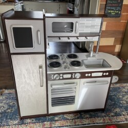 The repaired Uptown Expresso Play Kitchen, ready to be returned to service with Elliott!